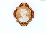 a picture of a woman in a gold broochle