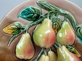 a ceramic plate with pears on it on a table
