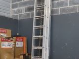 a ladder that is next to some boxes in a room