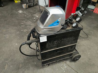 an image of a welding helmet on a cart in a garage