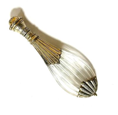 a silver spoon with a glass handle on a white surface