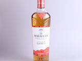 a bottle of macallan ' s earth whisky on a white background