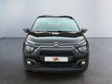 the front of a black citrole parked in a white room