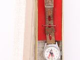 a watch sitting in a box on a white surface