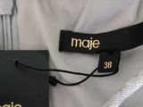 an image of a white dress with a black label on it