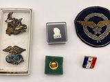 a box of pins and a badge on a table