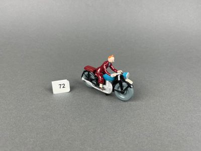 a small figurine of a man riding a motorcycle
