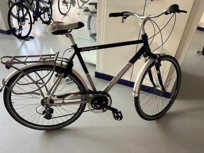 a bike that is parked in a room next to a mirror