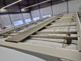 a large pile of wood on the floor of a building