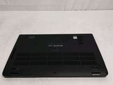 the back of a laptop with a black cover on a white surface