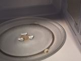 a white microwave with a metal pan inside of it