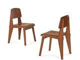 pair of wooden chairs with leather seats on a white background