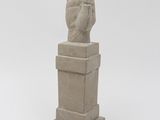 statue of a hand with a raised up finger on a pedestal
