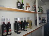 bottles of alcohol are lined up on a shelf in a liquor shop