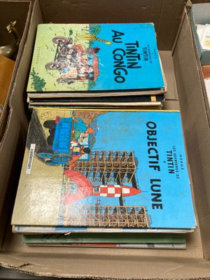 three books in a box on a table