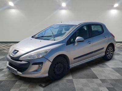 the small silver car is parked in a room with a checkered floor