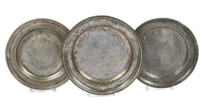 three silver trays sitting on top of each other on a white surface
