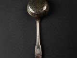 a spoon that is sitting on a black surface