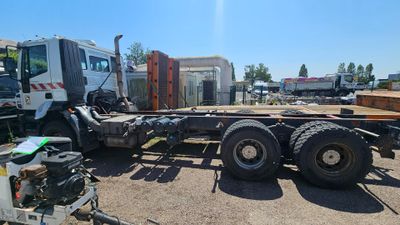a truck that is parked in a lot with other trucks