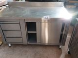 a stainless steel kitchen island with drawers and cabinets