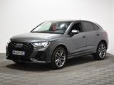 a grey audi suv parked on a checkered floor