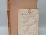 an old book with a piece of paper on top of it