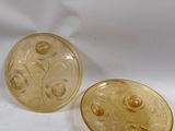 pair of yellow glass buttons with flowers and leaves on them