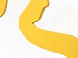 a yellow sculpture of a woman ' s face and a man ' s head