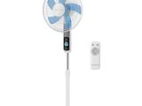 a white fan sitting on top of a stand next to a remote control