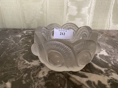 a small glass candle holder on a marble table