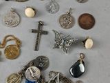 a lot of silver and gold jewelry on the table