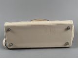 a white purse sitting on top of a gray surface