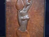 an image of a sculpture of a woman holding a basket