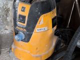 a yellow and black duster and a black vacuum on the floor