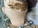 a close up of a mannequin head with beads on it