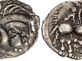 a silver coin with an image of a woman on it