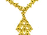 a close up of a gold necklace with green stones on it