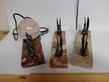 three pairs of scissors and a lamp on a table