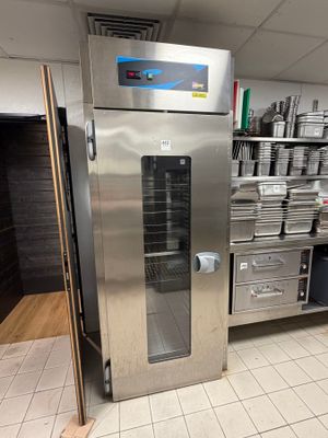 a large stainless steel oven in the middle of a kitchen