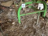 a green machine that is sitting in the dirt