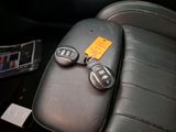 two remote controls on the back of a car seat