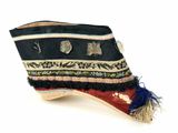 a black hat with a blue tassel on top of it
