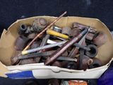 a cardboard box filled with various types of pipe smokings