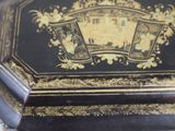 a black and gold box with a picture of a castle on it