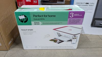 a box of printer sitting on the floor next to a cardboard box