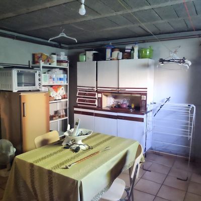 a table with a yellow table cloth on it in a kitchen