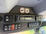 a picture of a car dashboard with buttons and a radio
