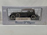 an old model of a car in a box on a white surface