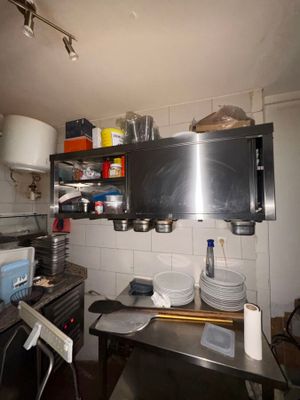 a kitchen with a lot of pots and pans on the counter