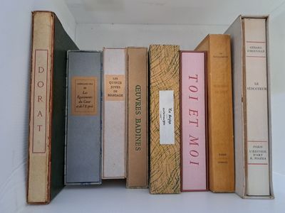 several old books are stacked on top of each other on a shelf